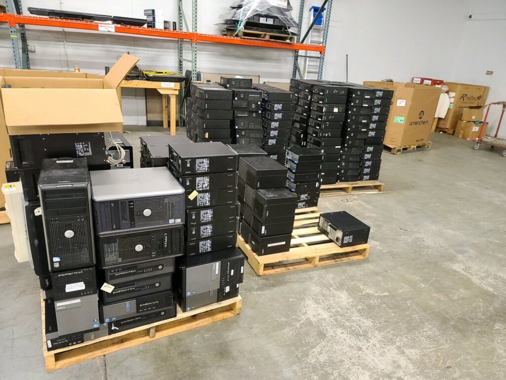 Stacks of computer towers and e-waste on pallets in the R3Ewaste facility in Phoenix, AZ
