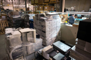 Large stacks of shrink-wrapped old computers and electronics awaiting recycling at Securis in Greensboro, NC