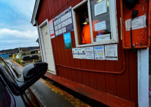A staff member assisting a customer at the scale house window of Windham Solid Waste Management District in Brattleboro, VT.