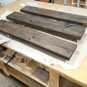 Three custom stained wooden shelves crafted by Twenty-Three Roses Woodworks in North Little Rock, AR.