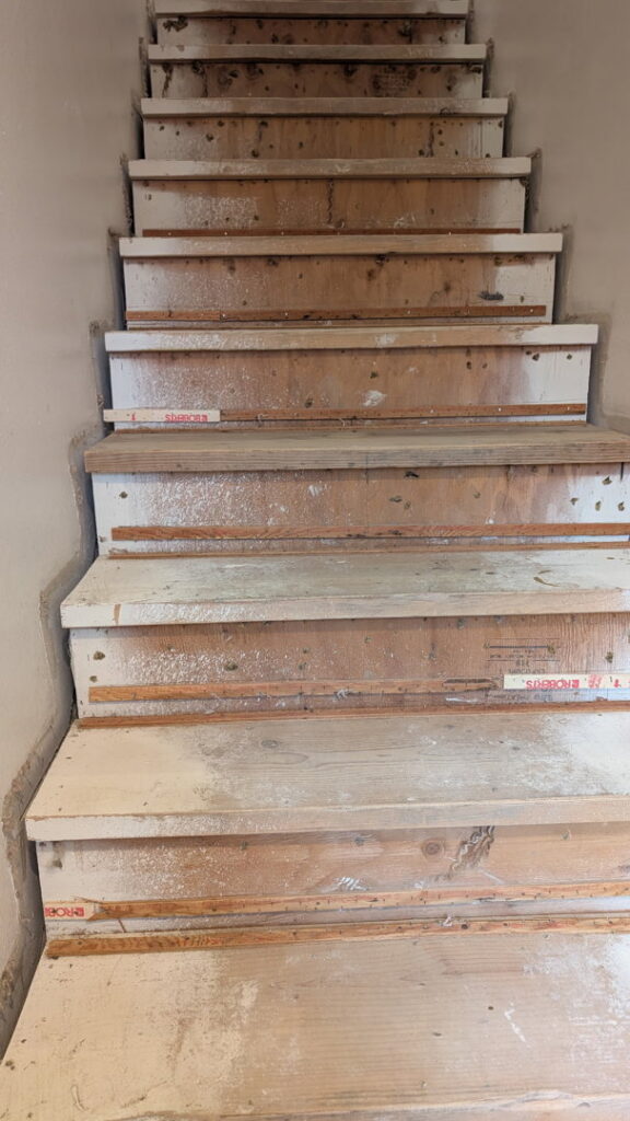 Staircase with old carpet removed, preparing for new flooring installation by Infinity Handyman in Anchorage, AK