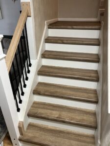 Newly installed stair treads, risers, and railing by Premier Handyman Services in Lexington, KY.