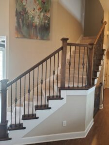 A beautifully renovated staircase with new balusters and handrails by Affordable Granite of KC in Kansas City, MO.