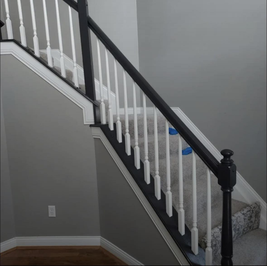 Staircase handrail and baluster painting with black and white finishes by Rock Creek Renovation and Painting in Waynesville, OH