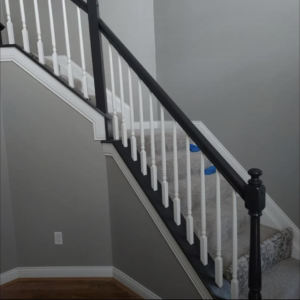 Staircase handrail and baluster painting with black and white finishes by Rock Creek Renovation and Painting in Waynesville, OH