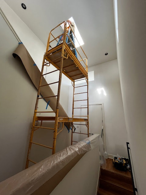 Staircase painting in progress with scaffolding and floor protection by San Marcos Drywall and Paint in Austin, TX