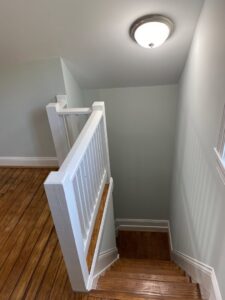 Newly installed staircase railing and ceiling light fixture by AES Electrical Contractor in Richmond, VA.