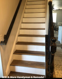 A remodeled staircase featuring new wood-look treads and white risers by Will.B.More Handyman & Remodel in West Jordan, UT