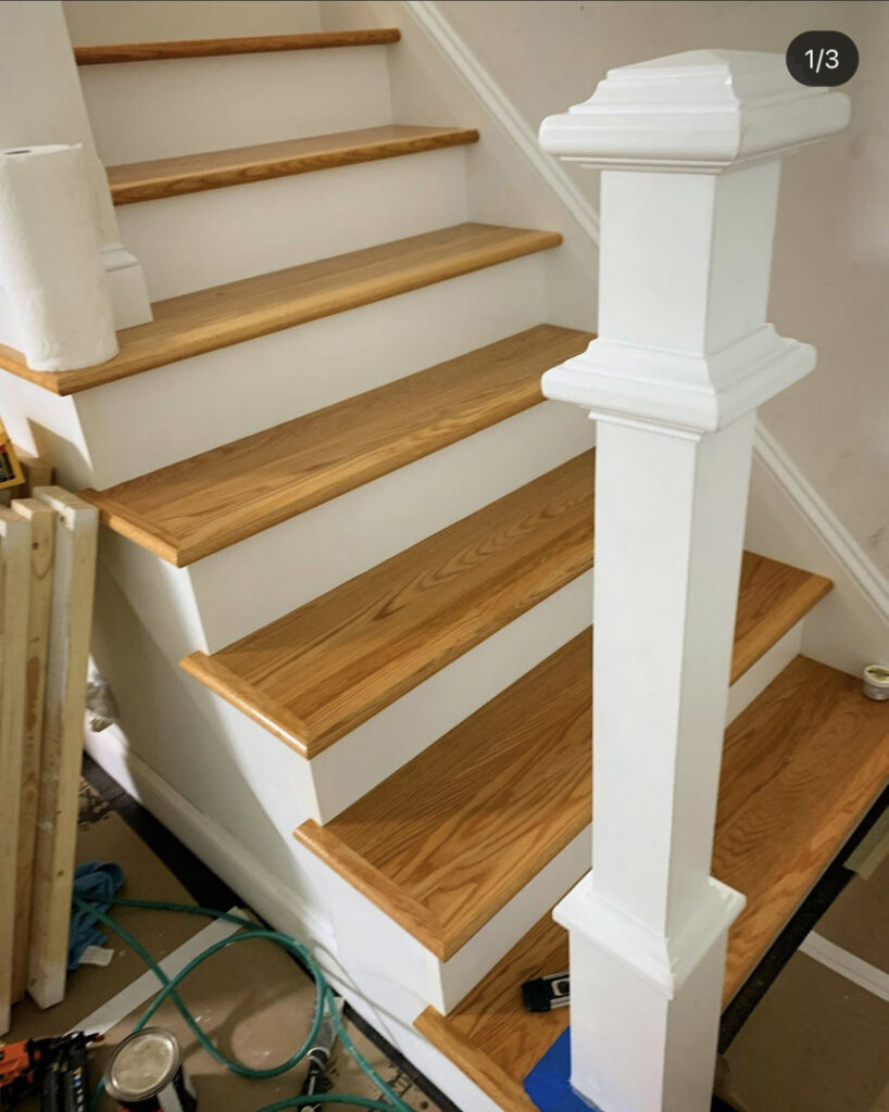 A staircase undergoing renovation with new wooden treads and white risers, showing a handyman installation project by Home pro handyman llc in Olathe, KS