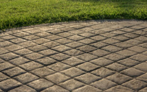 A beautifully installed stamped concrete patio with a diamond pattern, completed by concrete poured & installed - cp&i in Buffalo, NY.