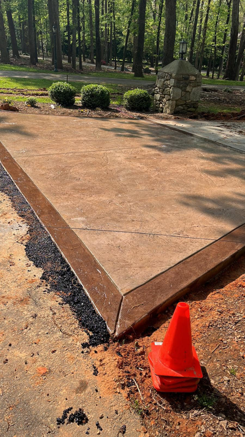 Newly installed stamped concrete patio section by Titan Built Construction, LLC, providing quality handyman services in Huntersville, NC.