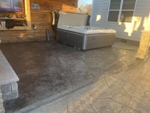 A beautifully finished stamped concrete patio featuring a hot tub, completed by Rodriguez Concrete Creations in Rock Hill, SC.