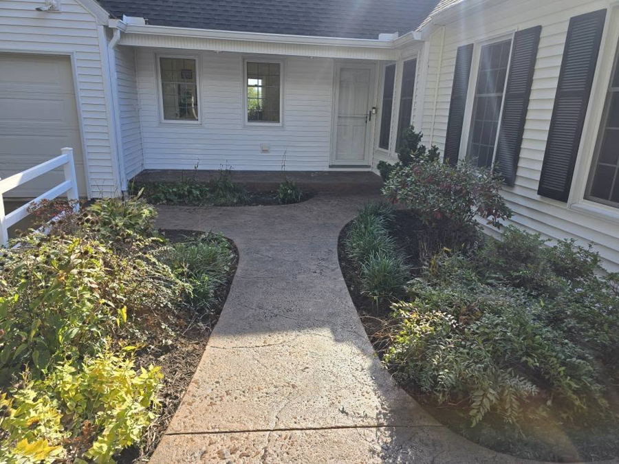 A newly installed stamped concrete walkway leading to a home, completed by J&M Concrete Construction, LLC in Fayetteville, PA.