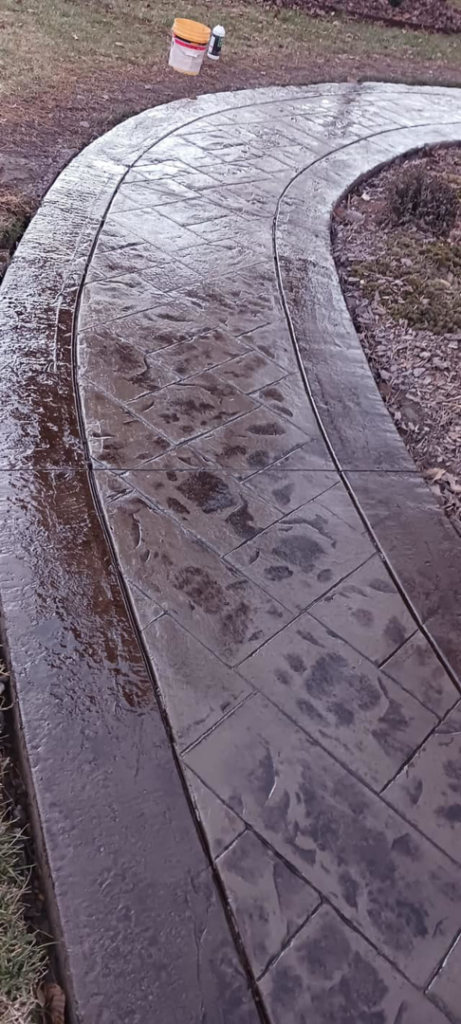 A newly installed stamped concrete walkway by Titan Built Construction, LLC, offering handyman services in Huntersville, NC.