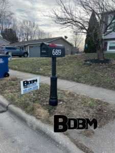 A standard black mailbox with house number 6819 installed by Big Dicks Brick Mailboxes in St. Louis, MO.