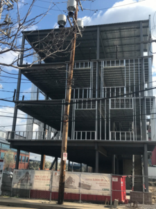 A steel structure building under construction with multiple floors by J S Construction in Finleyville, PA