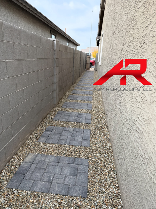A neatly installed stepping stone pathway on gravel in a side yard, a service provided by AGM Remodeling LLC in Scottsdale, AZ.