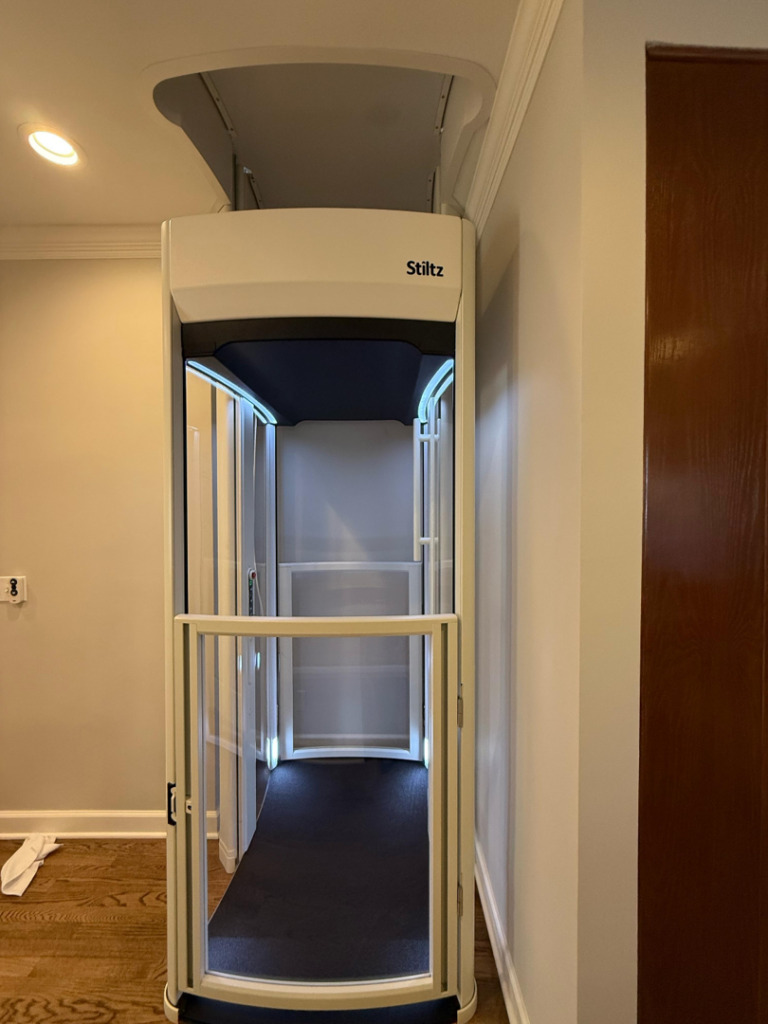 A Stiltz home lift installed in a hallway by Stiltz of Charlotte Raleigh Greenville in Concord, NC.