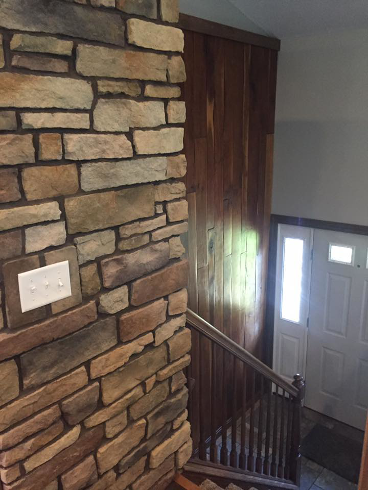 A custom stone accent wall and wood paneling installed by Kline Custom Homes and Remodelers in Canton, OH.