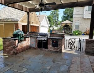 A custom stone fire pit and matching stone bench built by Rescue Landscaping and Outdoor Living in St. Louis, MO.