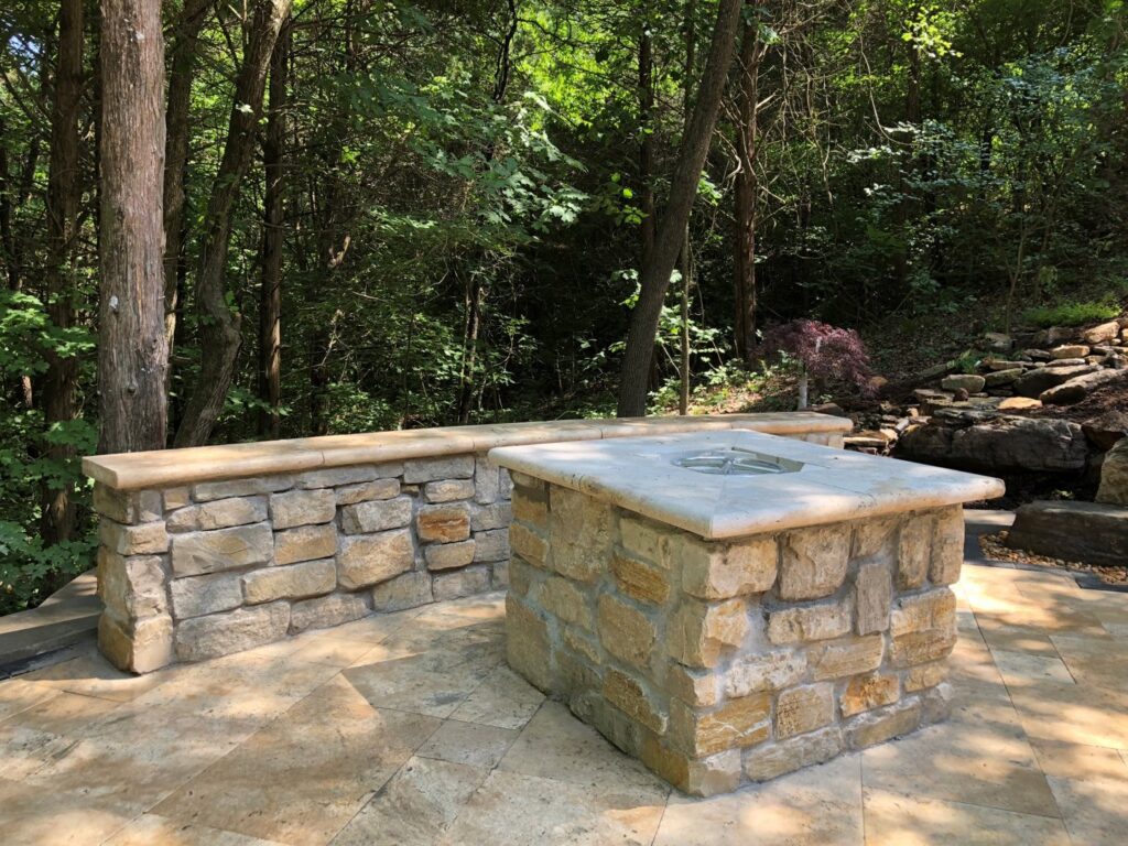 A custom stone fire pit and seating area built by Rescue Landscaping and Outdoor Living in St. Louis, MO
