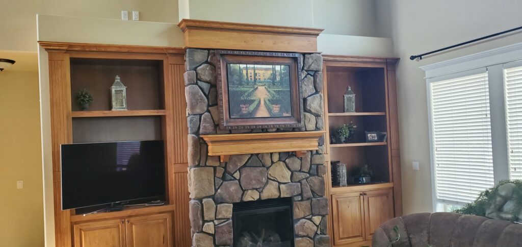 A beautifully finished stone fireplace with custom built-in shelves by Constructed by 360 LLC in Meridian, ID.