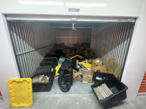 A cluttered storage unit filled with various items before junk removal by Junk Pros NW in Bellevue, WA.