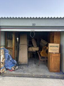 A storage unit packed with furniture and boxes, ready for junk removal or cleanout by CzechList Junk Removal in Scottsdale, AZ.