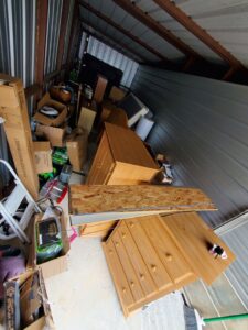A storage unit packed with furniture and boxes, ready for a cleanout by Sonny Day Junk Removal in Batesville, AR.