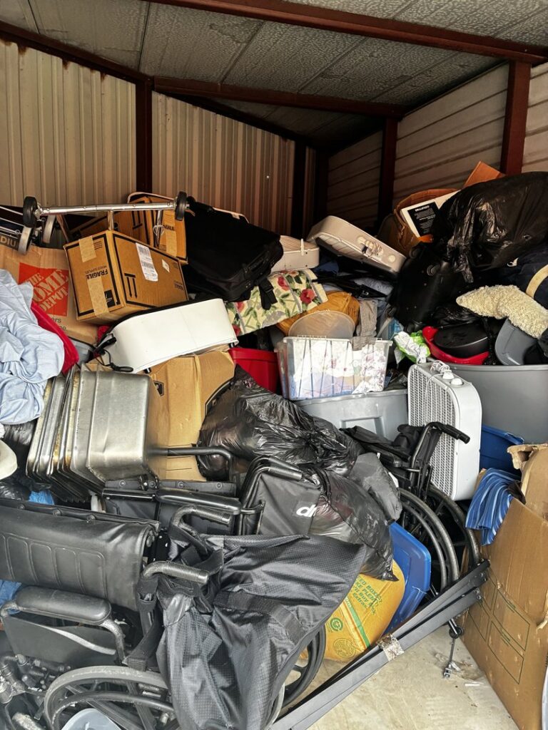 A cluttered storage unit packed with boxes, furniture, and miscellaneous junk, ready for Handymen Junk Removal in Houston, TX.