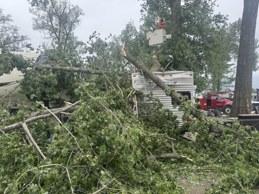 Emergency tree removal after storm damage, with a fallen tree on a camper, by JOCO Services LLC in Council Bluffs, IA.