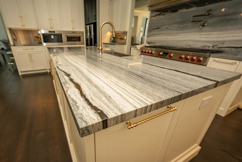 A close-up of a kitchen island with a unique striped marble or granite countertop by Accent Marble & Granite, Inc in Phoenix, AZ
