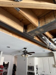 Structural beam installation during a kitchen renovation by Load Bearing Wall Pros in Plano, TX, opening up the space.