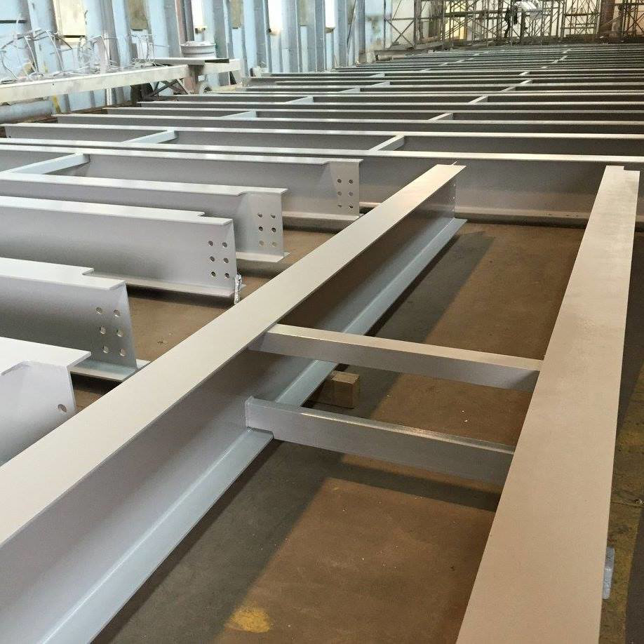 Large structural steel beams prepared for industrial coating by Carpenter Industries Inc. in Syracuse, NY.
