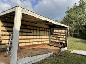 A structure undergoing demolition for junk removal services by JB'S Junk Removal in Justin, TX.