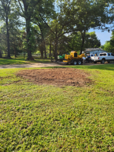 A stump grinder and a freshly cleared area after tree removal, showing services by Tree Worx in Darlington, PA.