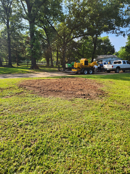A stump grinder and a freshly cleared area after tree removal, showing services by Tree Worx in Darlington, PA.