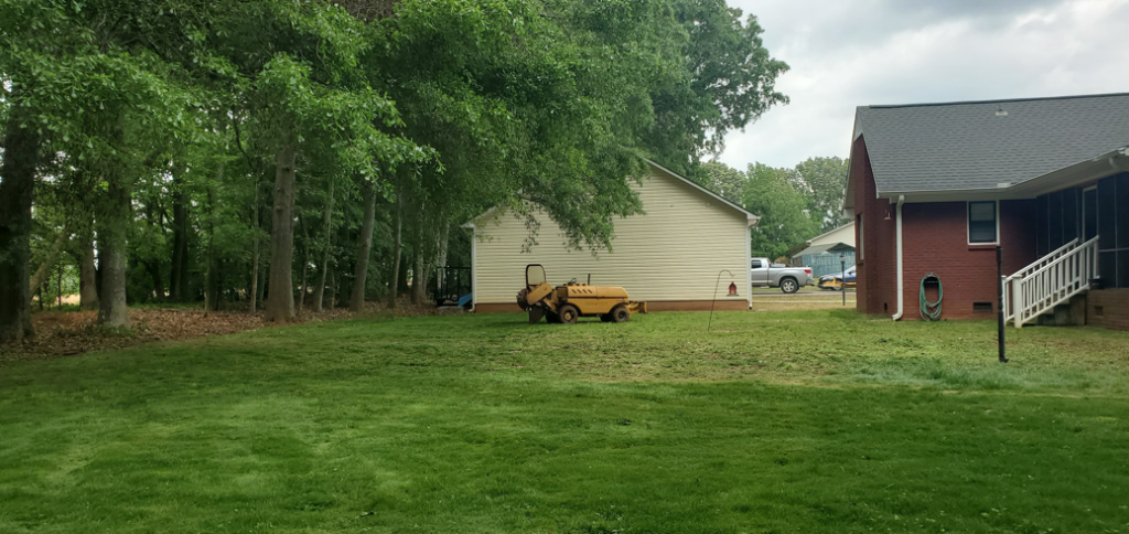 A stump grinder machine and wood chips after a tree removal by Chris's Tree Service in Hazel Green, AL