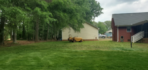 A stump grinder machine and wood chips after a tree removal by Chris's Tree Service in Hazel Green, AL