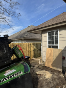 A Bandit SG-75 stump grinder in action, with sawdust on the ground, performing stump removal for Patriot Stump & Land in Montgomery, AL.