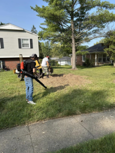 A crew from Jay's Tree and Lawncare performing stump grinding and cleanup services in Indianapolis, IN.