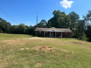 A freshly ground tree stump and cleared area in a residential yard by 865 Tree Care in Knoxville, TN.