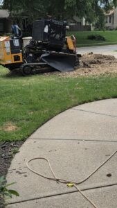 A professional stump grinding machine in action, providing stump removal services by M S Wiekhorst Arbor Company in Columbus, NE.