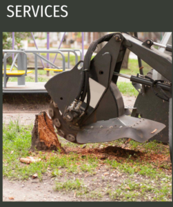 A stump grinding machine actively removing a tree stump as part of services by Green Land Tree services in Knoxville, TN