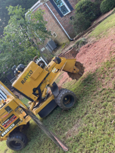 A stump grinding machine on a residential property for SDV professional tree service llc in Fyffe, AL.