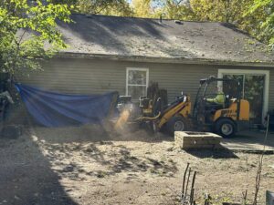 A professional stump grinder in operation, removing a tree stump in a backyard, provided by ES Tree Services Llc in Columbus, OH