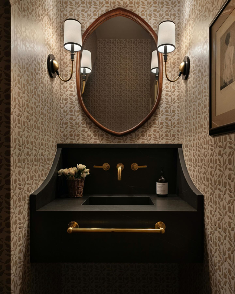 A stylish powder room featuring a unique vanity and mirror installed by ADAMS Pro Finish in Spring Hill, TN.