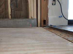 Subfloor and wall framing visible during a renovation project by Burleson De Lago Real Hardwood Floors in Austin, TX.