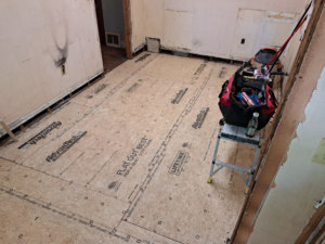 Subfloor installation in progress with tools visible, completed by Vest Home Services LLC in Greenville, SC.