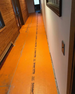 Subfloor prepared with Schluter-DITRA membrane for tile installation by D&J's Construction Services LLC in Denver, CO.